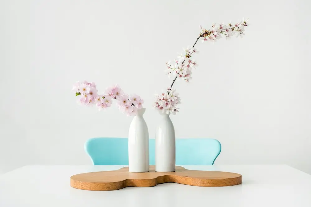 White ceramic vases with blossom branches